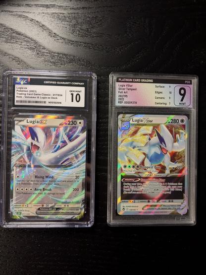 The picture shows two graded Pokémon cards encased in protective slabs.

The card on the left is graded as a 10, and the card on the right is graded as a 9.

Both cards is of Lugia and is holographic.