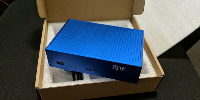 OpenWRT one wifi router sitting on it's open packing box.
It doesn't have it's wifi antennas screwed in.
It has a minimal clean looking aluminium enclosure