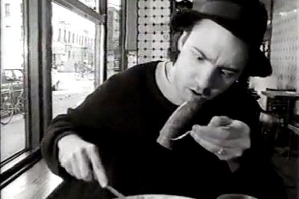 Still from Detachable Penis, of King Missile (?) boggling at a "wiener" on a fork.