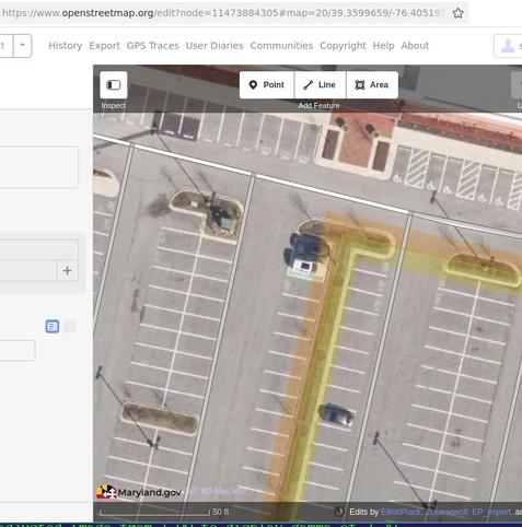 open street map aerial image of a parking lot; 2 vehicles near center in apparently marked spaces.