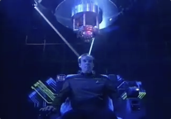 Lieutenant Barkley sits in a neuro-reading chair thing with lasers shining into three points of his skull.