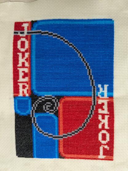 A cross stitch of the Fibonacci joker from the video game Balatro