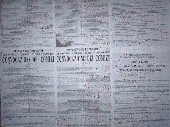 Posters hanging in the streets of Salerno.