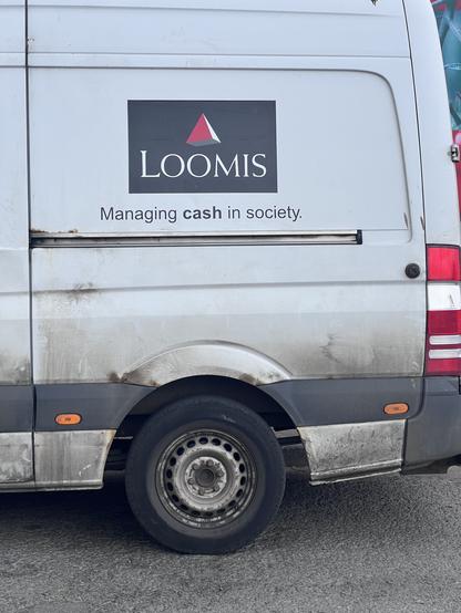 Pgoto The side of a white van with the phrase 'managing cash in society; on the side (the cash is in bold type)