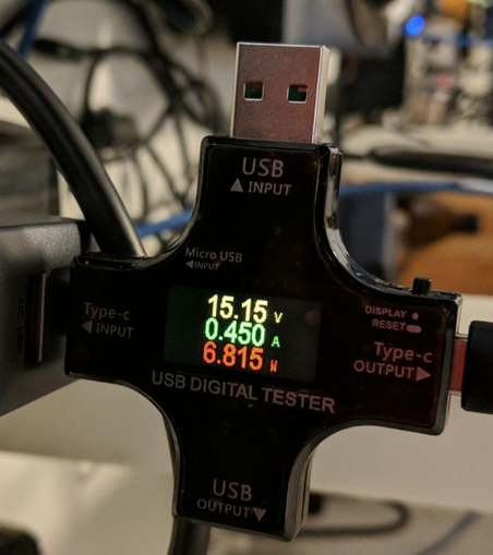 USB power tester, reading:

15.15 volts
0.450 amps
6.815 watts