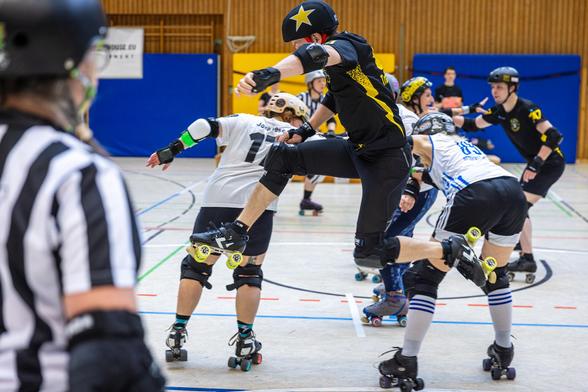 A colour picture of a roller derby player jumping the apex