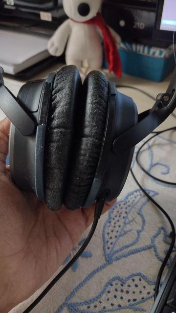 A pair of Bose high-end headphones that shows evident signs of plastic damage.