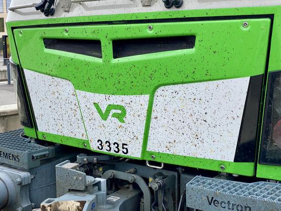 Sähköveturin keula on hyvin tiheästi törmänneiden hyönteisten täplittämä. Keskellä VR-tunnus ja sen alla numero 3335. Alinna vetolaitteita ja niiden vieressä metalliin lävistetyt tekstit ”SIEMENS” ja ”Vectron.