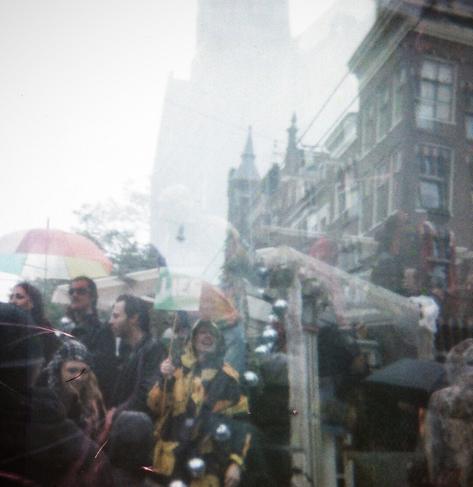 People dancing in the rain during a protest march against the (extreme) right.