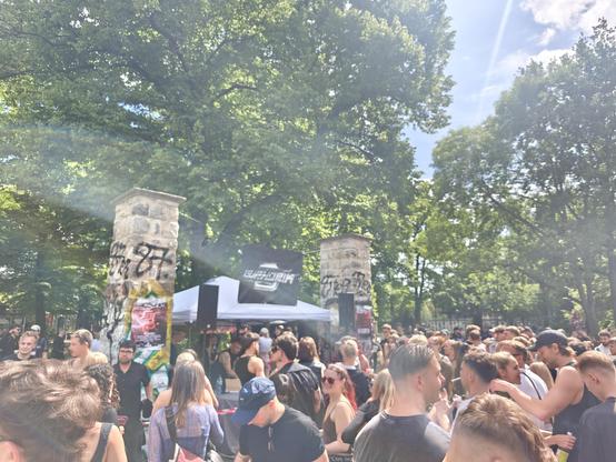 People dancing to techno music in front of a self organized stage in a park