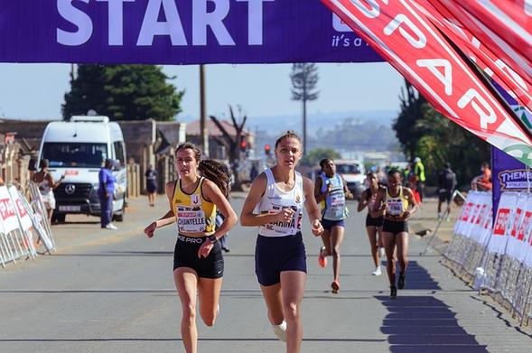 starting line of a race with runners coming across looking tired.