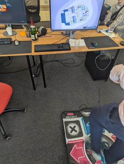 Photography of a desk with TRAILS running and a dance mat used as controller.