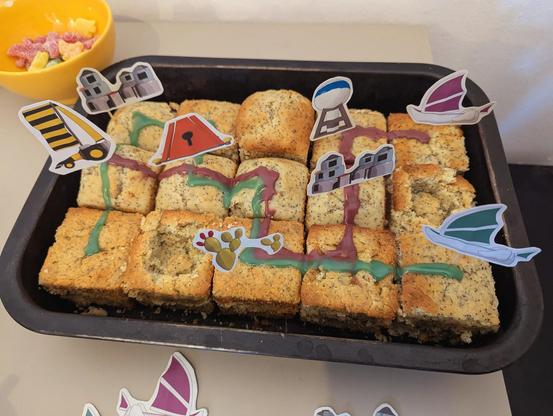 TRAILS themed muffins with deco pins showing outposts, ships, drones, gates and resources.