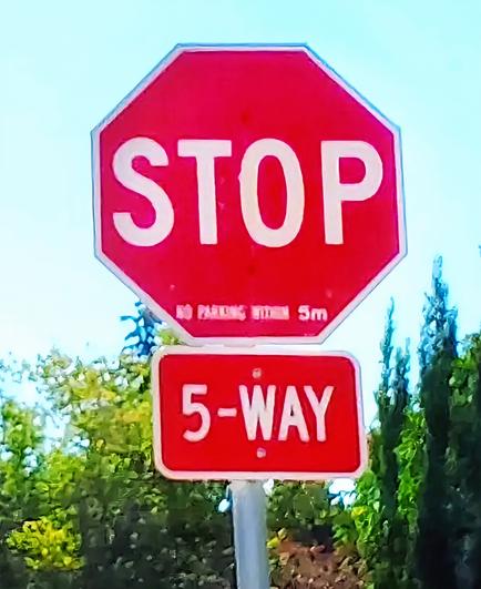 Stop sign at a five-way intersection.