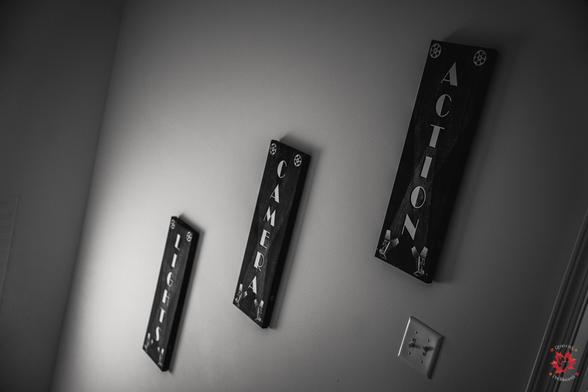 Landscape photo of cinema wall decor where it says "Lights, Camera, Action"