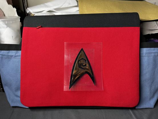 The same messenger bag flap now has a larger, 5” service insignia positioned in the center of the flap.