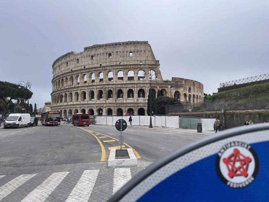 The AntiFascist Fediverse sticker stuck on a sign right in front of the Colosseum, in Rome
