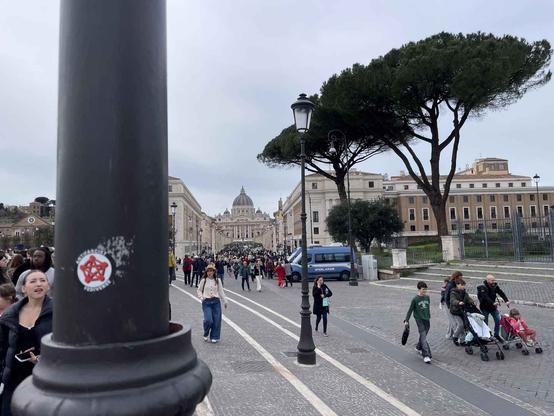 The AntiFascist Fediverse sticker stuck on a pole in front of San Pietro, in Vatican City (Rome)