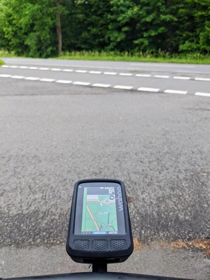 A GPS bike computer showing a map where the current location is shown across the street, but in reality the street is in front of it