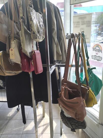 So many colourful purses on a rack