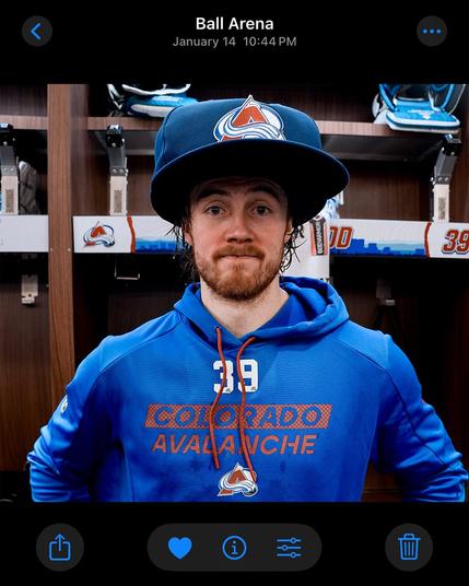 Mackenzie Blackwood wearing the big blue Avalanche hat in a Colorado Avalanche sweatshirt