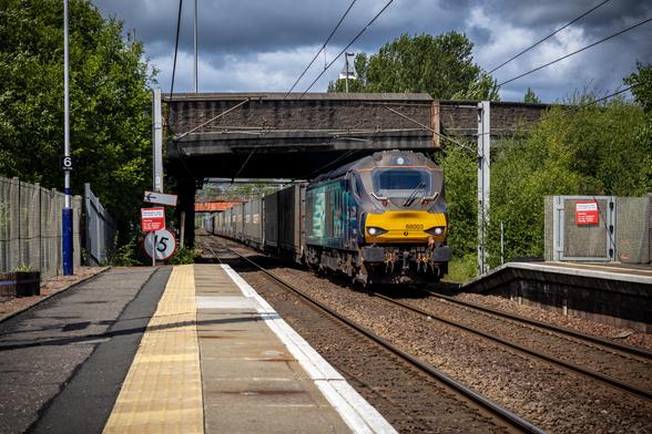DRS Class 68, 68003 pulling an intermodal train through Whifflet station under a road bridge