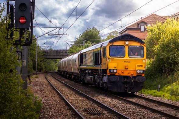 GBRf Class 66, 66741, hauling a rake of PCA wagons, round a corner