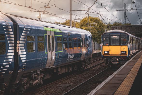 Scotrail Class 318. 318267 with another unit driving past the front of a ScotRail Class 320 on Platform 1 at Whifflet station as it pulls into Platform 2