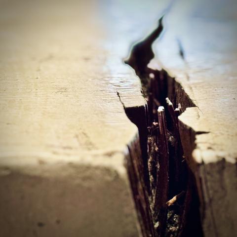 A small split in the side of a wooden coffee table somewhat resembles a giant chasm in stone.