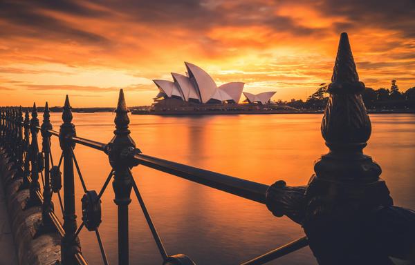 A fiery sunset behind Sydney Opera House.