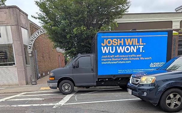 Truck that promises Josh Will reduce traffic but Wu Won't is parked straddling a no-parking zone and a crosswalk in Roslindale