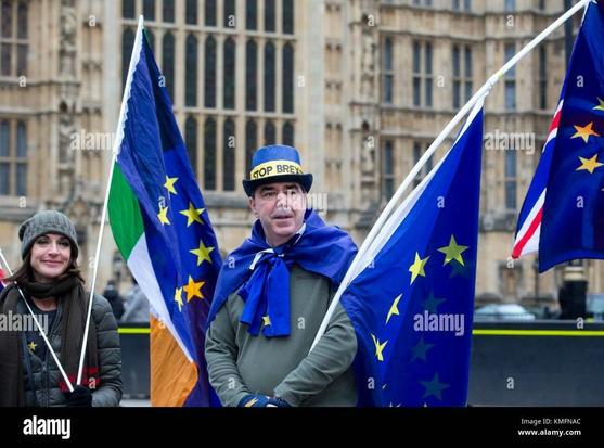 A man holds a sign reading "EU," symbolising support for the European Union.