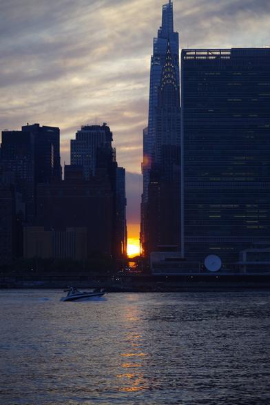 Sunset over 42nd Street, behind the East River. The full height of the Chrysler building and part of the United Nations can be seen on the right (north side).