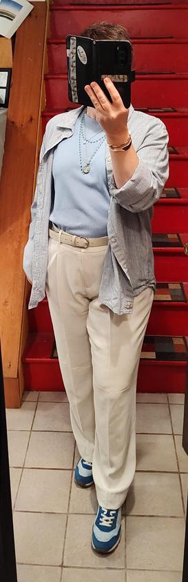 Pale blue T, white satin trousers, blue and white striped (very thin stripes) cotton button up layered like a jacket. Blue Adidas knock-offs, white belt, gold bangle bracelets, layered blue and white necklaces.