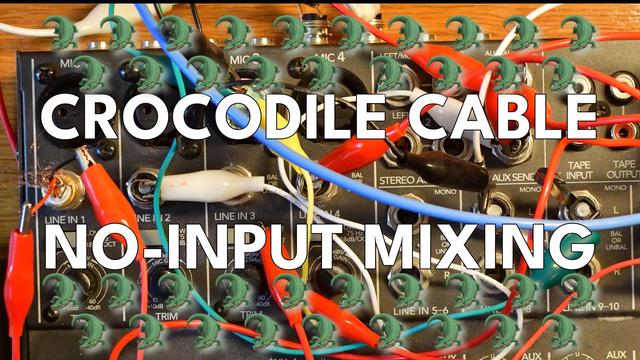 A mixer with lots of crocodile cables clipped onto connectors, with the text CROCODILE CABLE NO-INPUT MIXING and lots of crocodile emojis