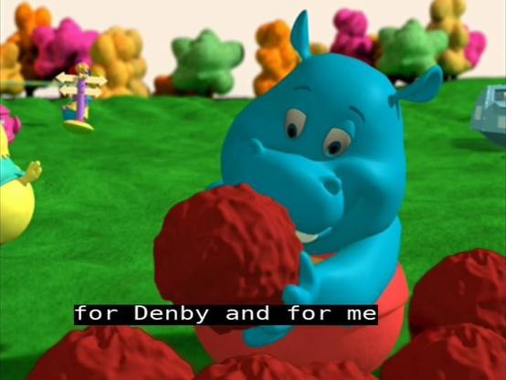 Still from Weebles episode "Spaghetti Days" (2005). Zuzie Q. and Diddy are having a conversation offscreen, while Demby (blue hippo with no legs wearing red bib overalls) is choosing a meatball to use as a bowling ball. The EIA-608 (line 21) caption has a spelling error: "for Denby and for me"