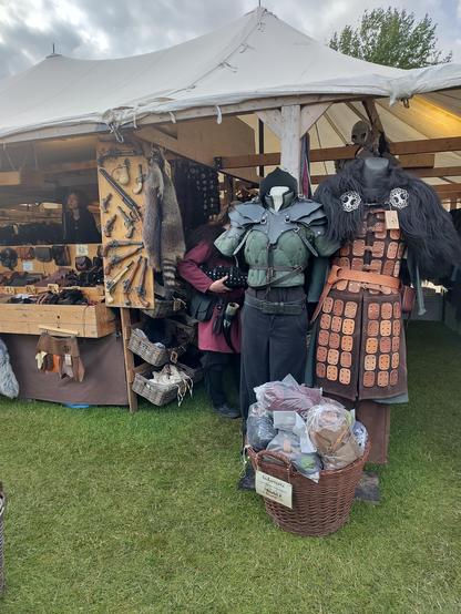 So ancient pistols and armour on a sales booth on a medieval market