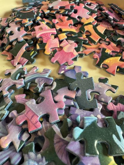 A close-up view of a pile of jigsaw puzzle pieces