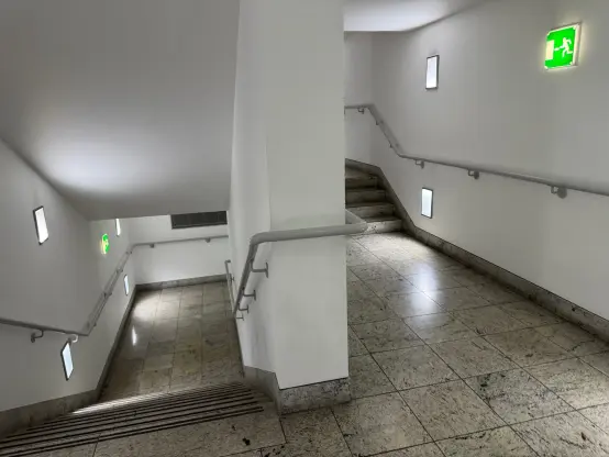 Some liminal staircases in a similar style to the corridor in the first picture.