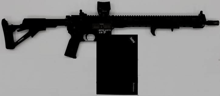 photomontage based on an AR-15 style assault rifle with cracked shoulder stock and scope mounted. A black Lenovo Thinkpad laptop has been pasted in front of the trigger guard (where usually the magazine is sitting)