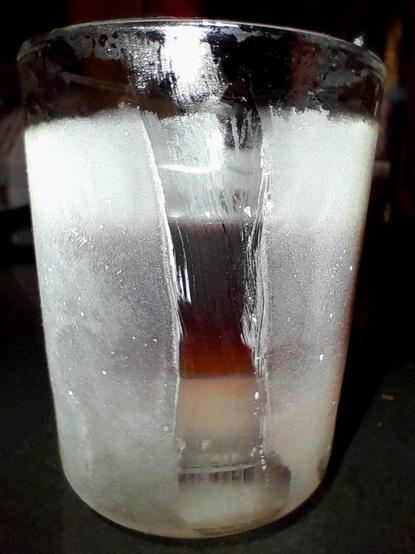 Subzero Mümmelman floats on a sea floor of water ice in frozen glass tumbler. 
I wiped a stripe clear in the ice condensing on the outside to show the layers clearly.
