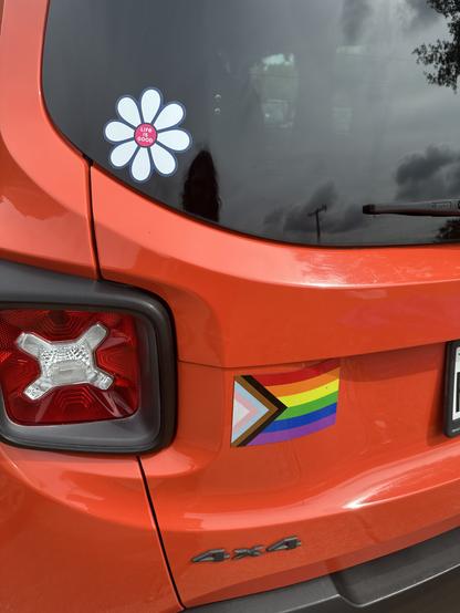 Progress pride flag on an orange car