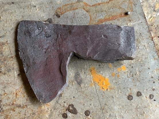 A small bearded axe made from a single piece of truck leaf spring. The forging is a bit rough, some of it will grind out, some won't.
