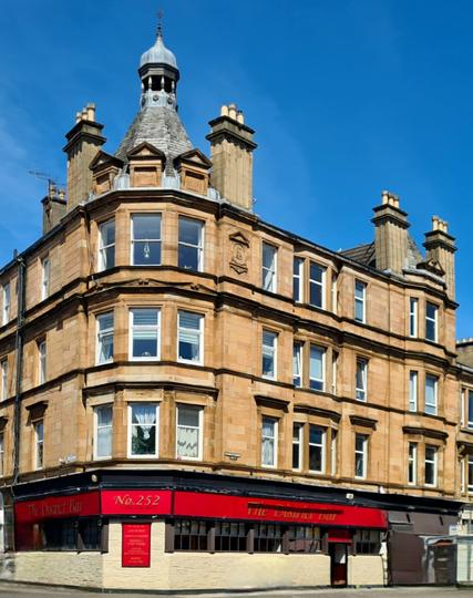 A corner tenement topped by an ornate cupola.