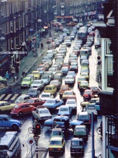 An Amsterdam street packed with colourful cars in gridlock in the 1970s.