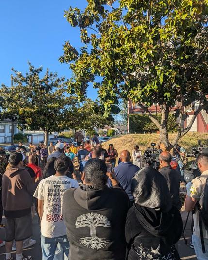 Photo of people gathered for a vigil at the intersection where Marvin was killed