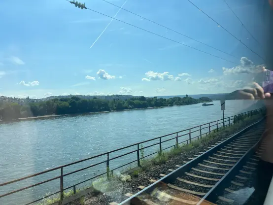 View down a straight section of the Rhine. the sun reflects off the river, making it glint here and there