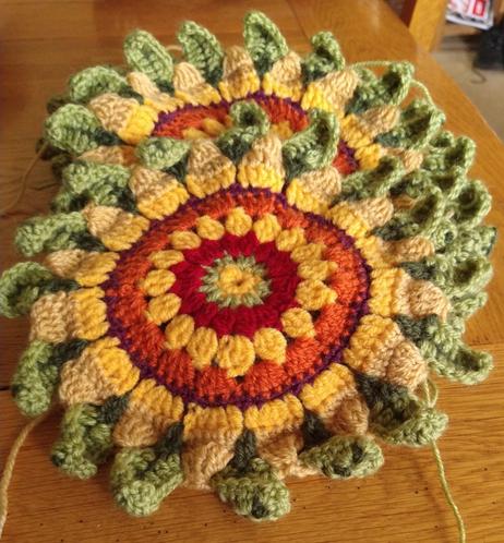 Sunflower design crochet flowers, part of a Jane Crowfoot Fields of Gold design 
They have green and red centres with yellow and green petals