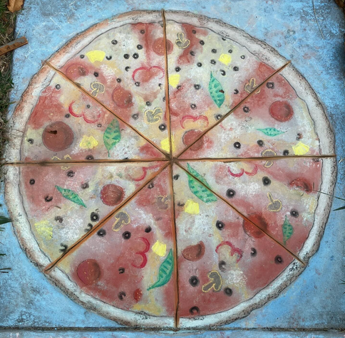 A chalk drawing of a pizza on pavement, with pepperoni, mushroom, bell pepper, basil, and pineapple toppings, cut into eight slices