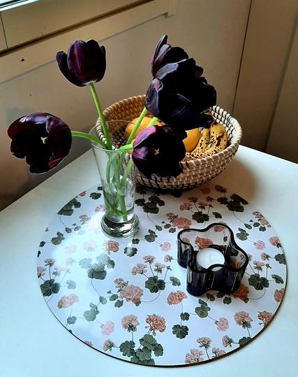 Black tulips on the table in a clear vase.